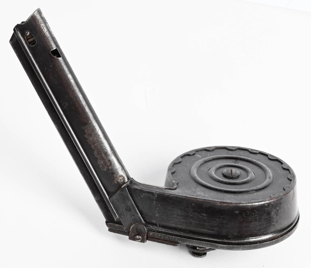 WWII GERMAN LUGER P08 32RD SNAIL DRUM MAGAZINE: Second Model snail drum magazine. Manufactured by the German toy company Bing for the German military. Drum holds 32 rounds. Serial number 582392 is on the front and back. CONDITION: It has a good sol