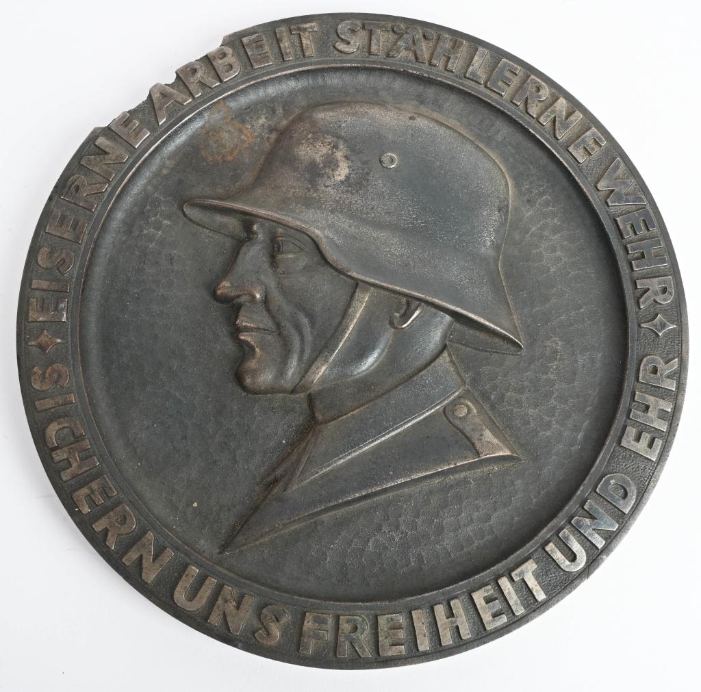 WWII NAZI GERMAN IRON PLAQUE OF WEHRMACHT SOLDIER: Large Steel plaque measuring 9 1/2 inches with the inscription "Sichern Uns Freiheit Und Ehr Eiserne Arbeit Stählerne Wehr" which translates to "Secure us freedom and honor Iron work Steel Defense" T