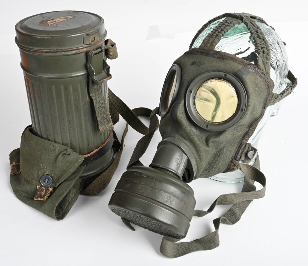 WWII NAZI GERMAN M30 GASMASK & CANISTER GAS WW2: M30 pattern cloth covered, rubberized canvas gas mask. Mask is complete with all straps. Included is a "FE" 37 dated filter. Comes with its early, 25cm tall M30 Gasmask canister. Retains a good portio