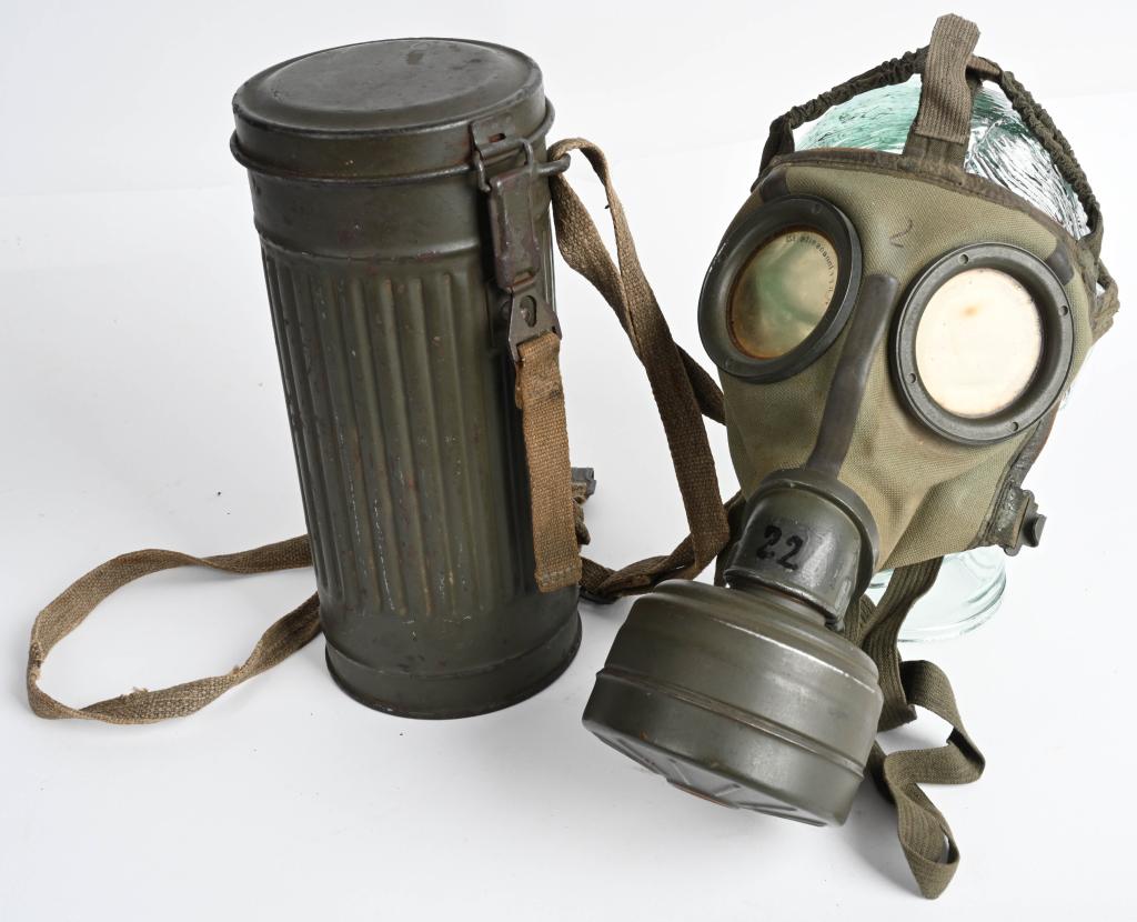 WWII NAZI GERMAN M30 GASMASK & CANISTER GAS WW2: M30 pattern cloth covered, rubberized canvas gas mask. Mask is complete with all straps. Size marked "2". Included is an FE41 filter. The mask comes housed in a second pattern M30/38 corrugated magnet