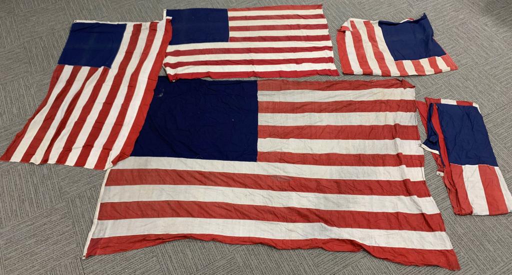 6 UNFINISHED US FLAGS WITHOUT STARS: 6 Vintage American Flags, each one has 13 red and white stripes, and a blue field, but none have had their stars printed or embroidered on. Unclear whether these are unfinished from the factory or whe