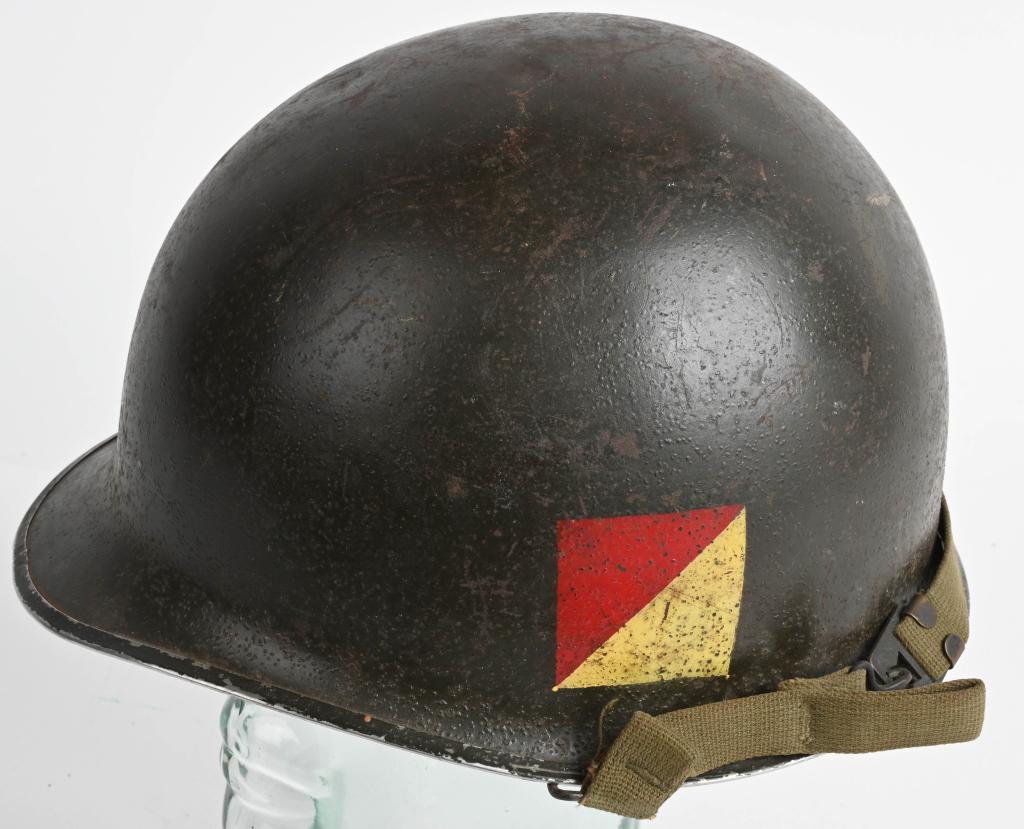 WWII US M1 COMBAT HELMET UNIT PAINTED W/ LINER: WWII US Army unit insignia painted M1 front seam swivel bail combat helmet with liner and chinstrap. The helmet has a heat lot 751B and is named to Pvt. McMahon ASN 36028262 or something close to that