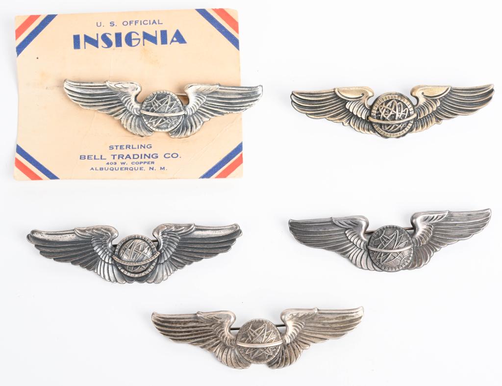 WWII US AIR CORPS NAVIGATOR WING LOT OF 5 WW2: WWII US Army Air Corps Navigator wing lot to include 1) Bell Trading Post 3 inch pin backed wings 2) Sterling pin back wings measuring 3 inches 3) Gemsco Sterling pin back wings measuring 3 inches 4) 