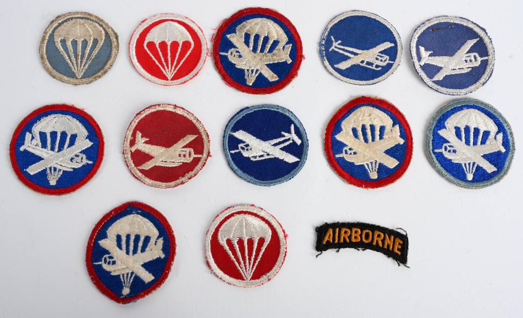 WWII US ARMY PARATROOPER CAP INSIGNIA AIRBORNE WW2: Collection of 13 WWII US Army Paratrooper officer's and enlisted cap insignia from the infantry and to artillery all are excellent and to the period of WWII. Excellent