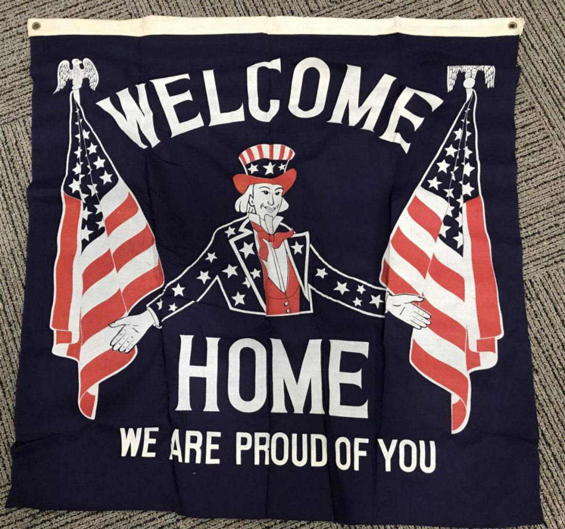 WWII US PATRIOTIC BANNER W/ UNCLE SAM WW2: Large banner measuring 35 X 43 inches excluding gold fringe with a patriotic theme with Uncle Sam with the text \"WELCOME HOME WE ARE PROUD OF YOU \" The red, white and blue banner is made of cotton a