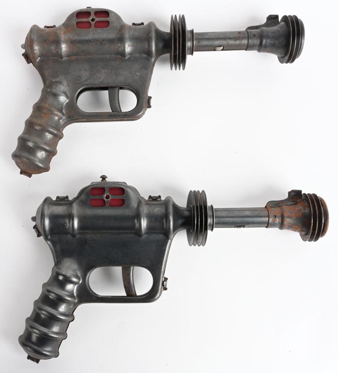 2- VINTAGE DAISY BUCK ROGERS ATOMIC RAY PISTOLS: Nice pair of original pistols. One did not work when tested. Should clean to a higher grade. 10" Good-Very Good