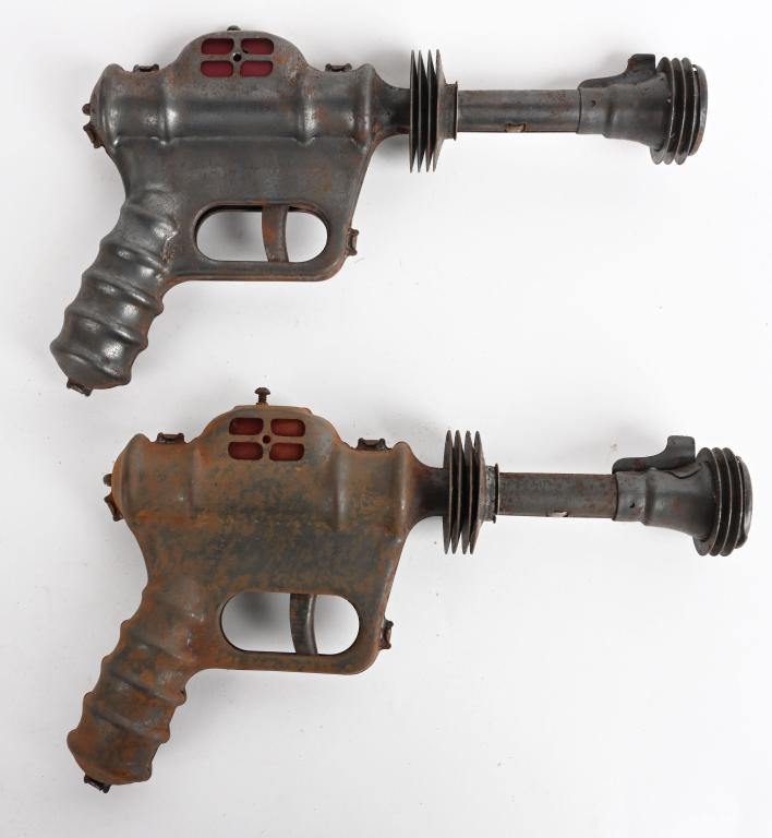 2- VINTAGE DAISY BUCK ROGERS ATOMIC RAY PISTOLS: Nice pair of original pistols. Both worked when tested. Should clean to a higher grade. 10" Good-Very Good