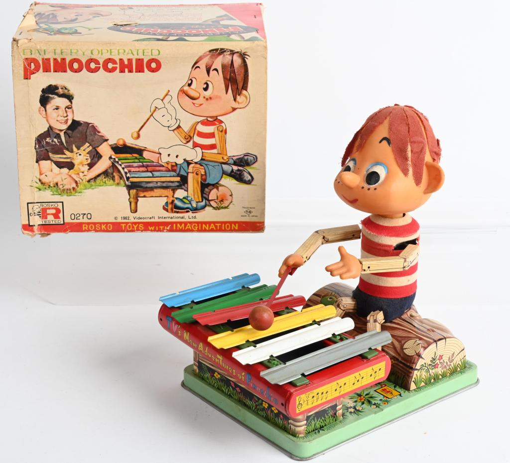 JAPAN 1962 TIN Battery Op PINNOCHIO w/ BOX: The toy is in nice original condition with a clean battery box. It worked when tested. The toy is complete, but the rubber "bumpers" under the keys have deteriorated. Colorful original box has some we