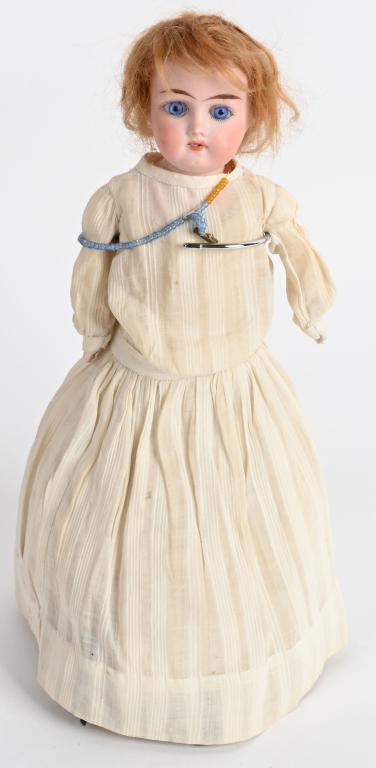 PETITE LILLY BISQUE GERMAN DOLL: Her head is stamped Lilly 13/10. She measures a mere 13 1/2". Facial features include open mouth with exposed teeth, piercing deep blue glass eyes, dimples, strawberry blond human hair wig with a whit