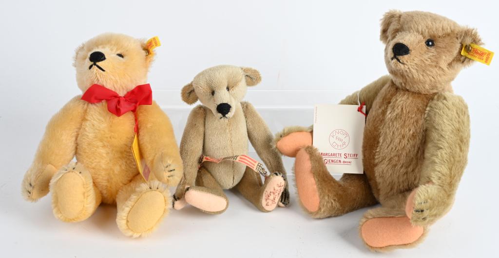 LOT (3) ENGAGING TEDDY BEARS - STEIFF: Two bears in this lot were made in German by the famous Steiff firm. One is the 1909 Original Teddy Bear with booklet, hang tag, ribbon and ear button. He stands 10" tall and is a blond bear. He has g