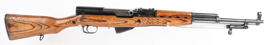 RUSSIAN MODEL 45 SKS RIFLE WITH LAMINATED STOCK: SERAIL NUMBER AB5999 BARREL 20" CALIBER 7.62X39 MANUFACTURED 1954. Produced in Russian with laminated stock, blue finished steel with folding blade bayonet. 10 round drop magazine and chrome lined bor