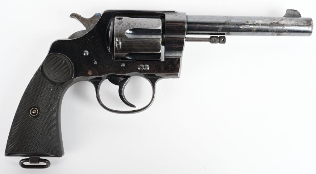 EARLY COLT NEW SERVICE REVOLVER: SERIAL 21184. BARREL 5.5" CALIBER .45 COLT. MADE IN 1909. Early type with non-tapered barrel, six shot, factory blue finish, Colt gutta percha grips and lanyard ring. This is a high polish range with 