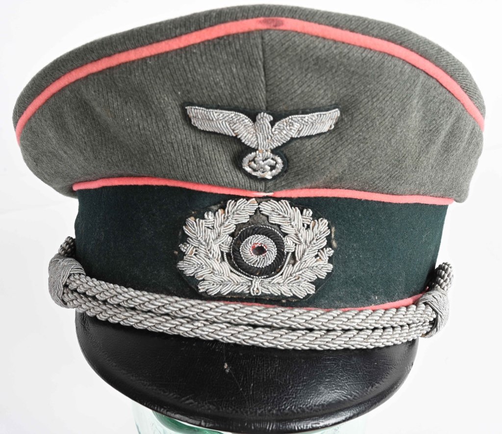 WWII NAZI GERMAN PANZER OFFICER: Field-gray wool/rayon blend body and crown, with a blue/green badge cloth centerband with pink wool waffenfarbe piping to the crown edge and both the top and bottom edges of the centerband. The front 