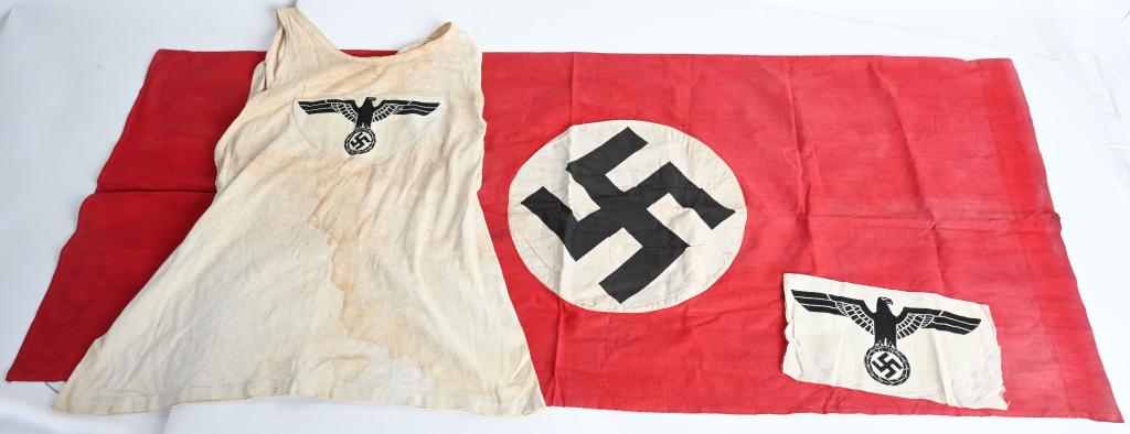 WWII NAZI GERMAN WEHRMACHT ATHLETIC SHIRT & FLAG: WWII Nazi German enlisted / NCO athletic shirt with extra sports shirt emblem. Shirt is soiled with a couple of minor tears. Shirt is roughly a large. The insignia consists of a white, rayon, half-moo