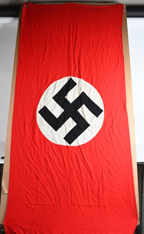 WWII NAZI GERMAN NSDAP NATIONAL FLAG OR BANNER WW2: Multi-piece cotton construction banner approximately 46 x 116 inches. To both its red fields are sewn white disks, with a printed mobile swastikas in black. Shows the expected period use and wear but