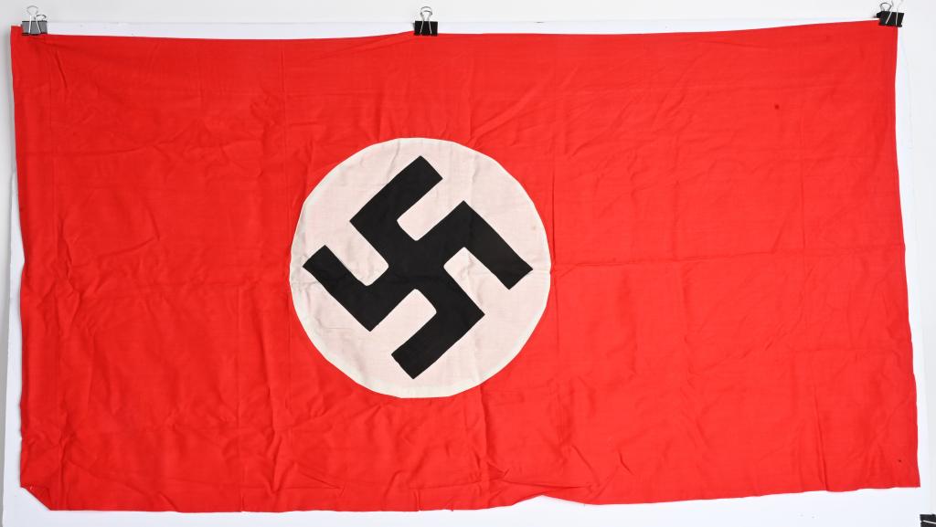 WWII NAZI GERMAN NSDAP NATIONAL FLAG WW2: To both its red fields are sewn diameter white disks, with a multi piece mobile swastikas in black. Shows the expected period use and wear but overall near mint condition measuring 26X51 inches. Proba