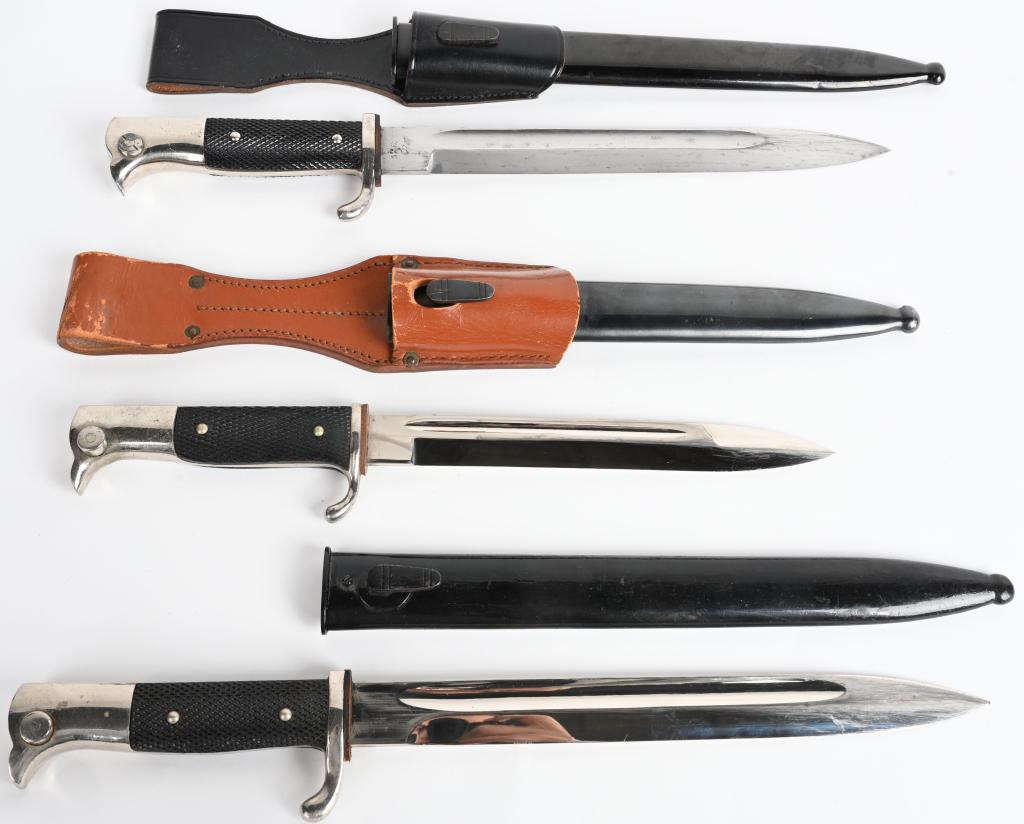 3 WWII NAZI GERMAN DRESS BAYONET LOT OF 3 WW2: A grouping of three WWII Nazi German dress bayonets to include 1) Marked "WKC" with a knight logo at the ricasso. 9.8" blade with a 1.8" false edge, 14.6" overall length. Has black composite grips and