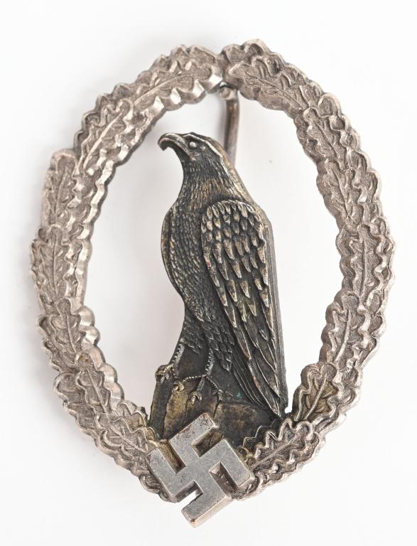 WWII NAZI GERMAN LUFTWAFFE RETIRED PILOTS BADGE: A Scarce Retired Luftwaffe Pilot's Badge; In Nickle Silver with fine and sharp details in slightly worn condition. The badge came into existence on 26 March 1936. It was to be placed on the lower left