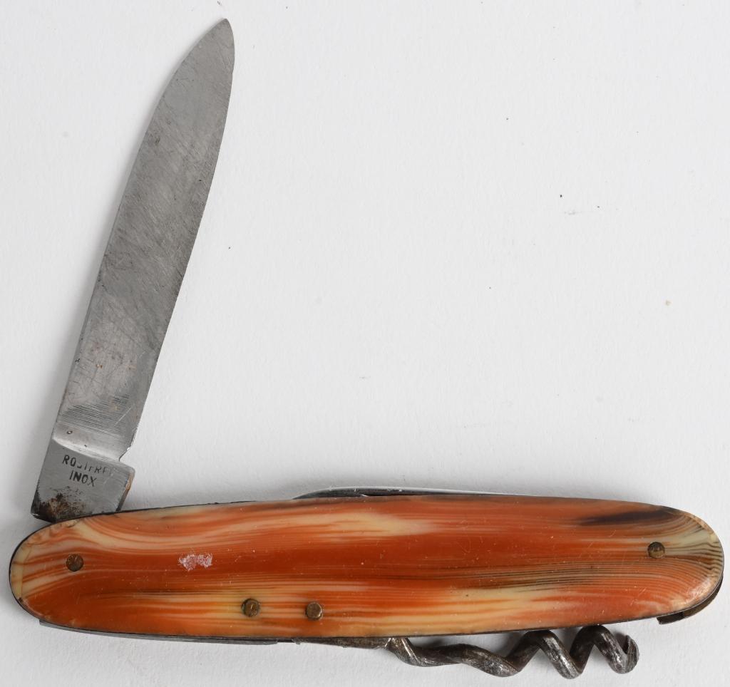 GERMAN OMEGAWERK PEN KNIFE WITH CORKSCREW: Celluloid handle, three-blade pen knife marked "Rostfrei INOX" on both blades, larger blade is also marked "OMEGAWERK SOLINGEN GERMANY." Has corkscrew. Large blade is 2.25" and small blade is 1.6" Whe