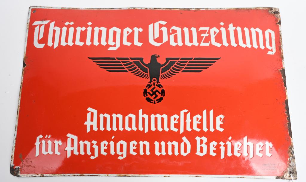 WWII NAZI GERMAN ARMY NEWSPAPER SIGN FOR Thüringer: Exceptional original enamel sign that is a Red rectangular wall plaque with white border. In the upper part in white Gothic the inscription for the newspaper is positioned. Beneath this is a later nat