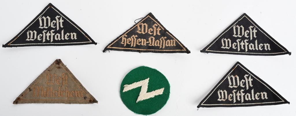 WWII NAZI GERMAN HITLER YOUTH SLEEVE TRIANGLE LOT: WWII Nazi German Hitler Your Triangle lot to include 1) BDM "WEST HESSEN-NASSAU" DISTRICT SLEEVE TRIANGLE. A woven black rayon constructed isosceles triangle featuring machine woven Gothic script in t