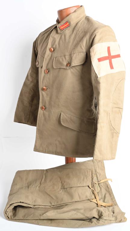 WWII JAPANESE RED CROSS WINTER SERVICE UNIFORM: A high quality, fully-lined, issued service tunic constructed from olive drab colored cotton. Its single-breasted front closure has four, flat buttons to it, each of which are of gold/brass-colored me