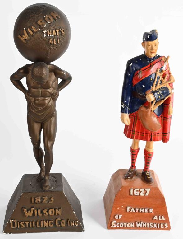 2- ORIGINAL WHISKY ADVERTISING FIGURES: Includes 1627 Scotch Whiskey and 1823 Wilson Distilling Co advertising figures. Both original with some wear. Largest 17" Very Good
