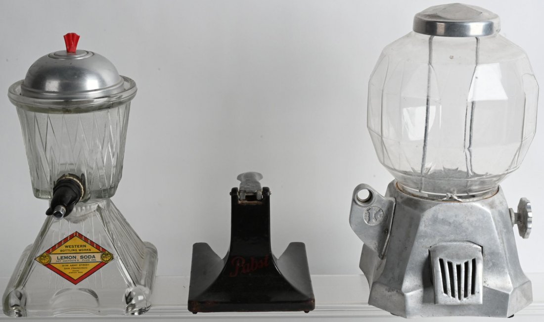 PABST BAR CAN OPENER, LEMON SODA DISPENSER & MORE: Lot includes a porcelain and iron Pabst bar back can opener, a 13" Western Bottling Works Lemon Soda dispenser, and a peanut vender with reatoration started. The peanut vender has chipped glass, and s