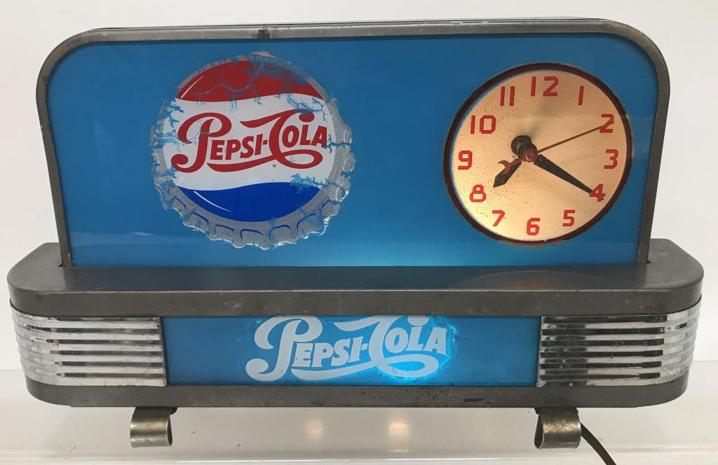 PEPSI COLA DECO STYLE LIGHT-UP CLOCK: Nice Pepsi Cola Deco Style Light-Up Clock. Nice glass with metal case and chrome accents. Lighted up and clock worked when tested. Shows some age. Looks great with nice colors. A Rare Pepsi Cola item!