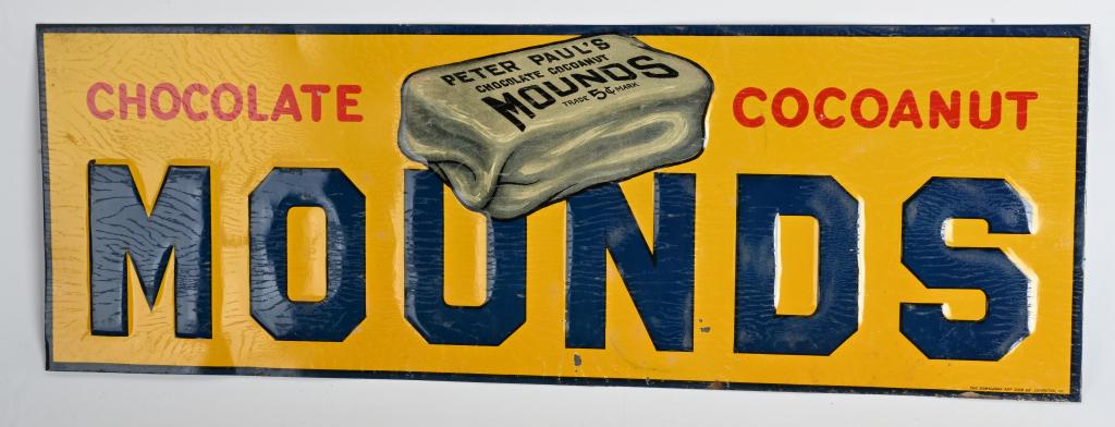 1930s MOUNDS EMBOSSED TIN SIGN: No wear with only the lightest of small edge rust and mild wood grain from old protective paper. 19 1/2" Excellent