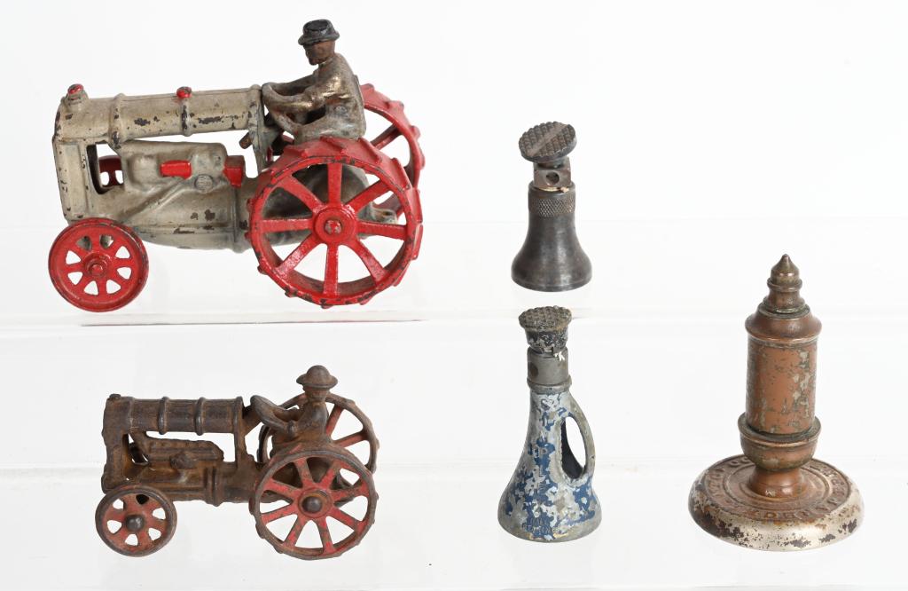 2- ARCADE CAST IRON TRACTORS & MORE: Pair of Arcade cast iron Tractors, Toy Jacks, and Toy Steam Whistle. Tractors are all original with no breaks. Largest 5 1/2" Very Good-Excellent