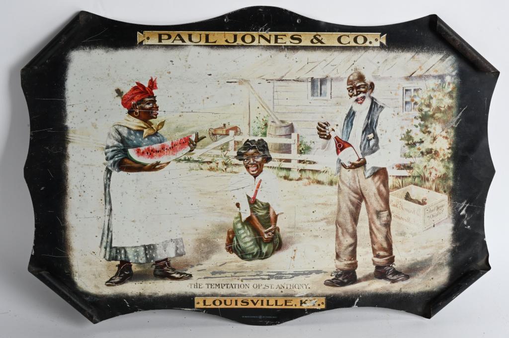 TOM JONES WHISKEY "BLACK AMERICANA" TIN SIGN: Tom Jones Whiskey "The Temptation of St. Anthony" curled corner tin Sign. Image of you black boy being tempted by black man and woman with watermelon and whiskey. Marked The Meek Company Coshocton Ohi