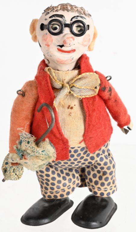 GERMAN TIN WINDUP MAN WITH UMBRELLA: Unusual windup man with umbrella. Windup works. 5 1/2" Very Good-Excellent
