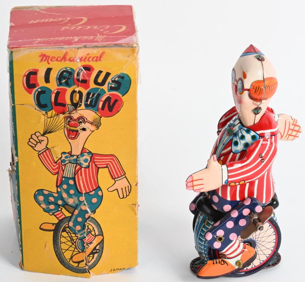 JAPAN TIN WINDUP CYCLING CIRCUS CLOWN w/ BOX: Scarce variation of Cycling Clown that is all original and works. Bright colors and great action. The colorful original box is fair with tape and missing end flap. 6". Excellent