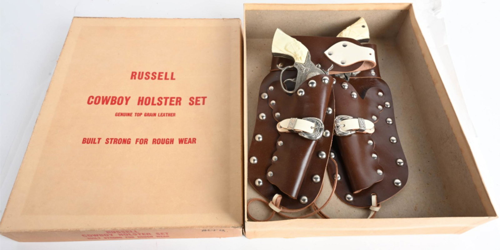 RUSSEL 2 CAP GUN & HOLSTER SET w/ BOX: Includes 2 Smoky Joe Cap Guns with Leather Holster. All original. Boxed 15" Excellent