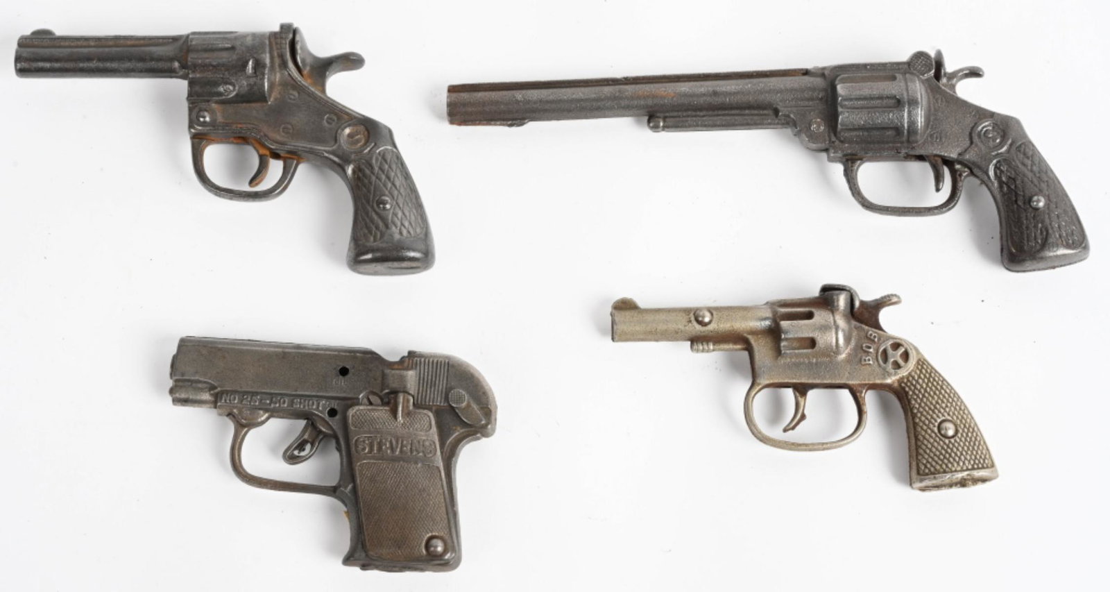 4- VINTAGE CAST IRON CAP GUNS: Includes Bob, Stevens, Lomg S, and W. All original. Largest 9" Very Good-Excellent