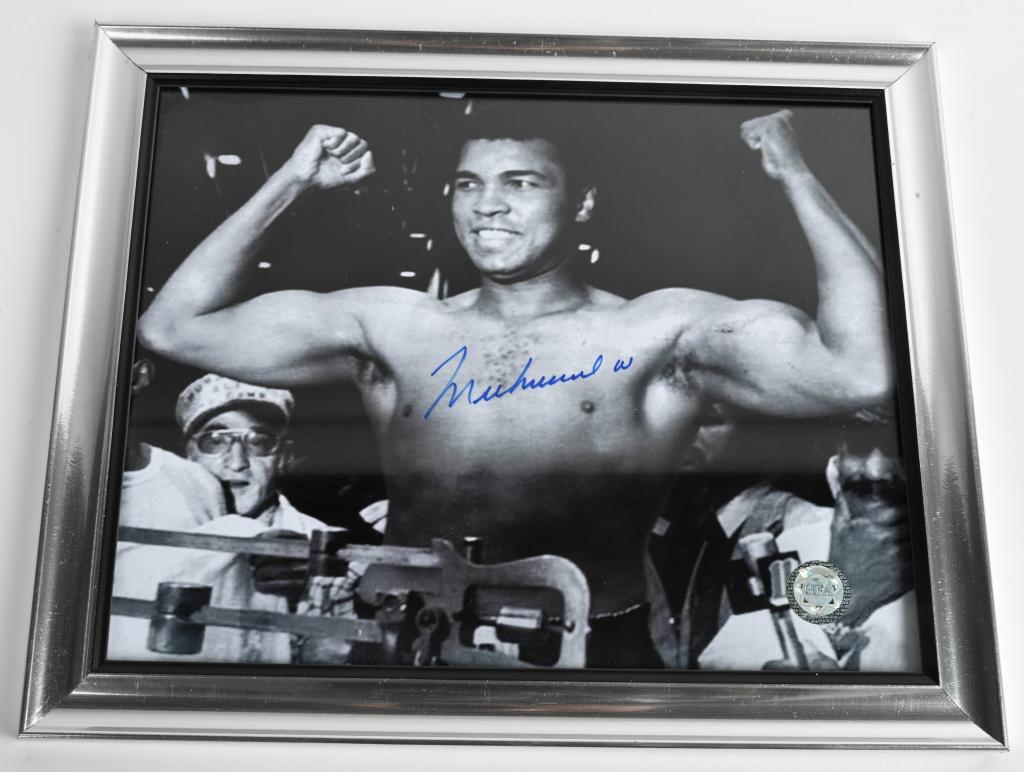Muhammad Ali autographed 8x10 photo: Signed in blue sharp and comes with cert.