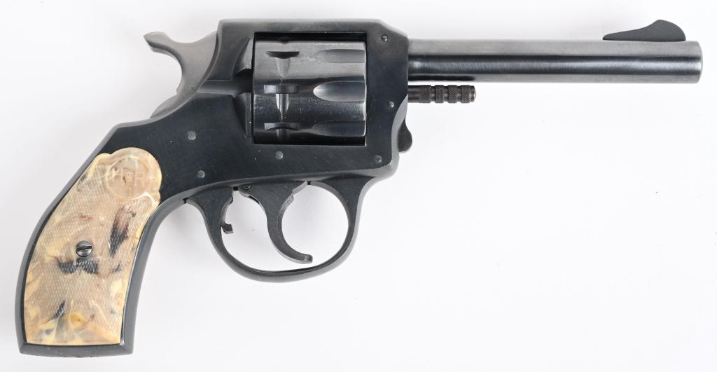 EXCELLENT H&R MODEL 922 REVOLVER: SERIAL M4769. BARREL 4". CALIBER .22 RIMFIRE. Made from 1950-1982. This nine shot double action features fluted cylinder, blue finish, fixed sights with mottled white & gray plastic grips. Appears to 