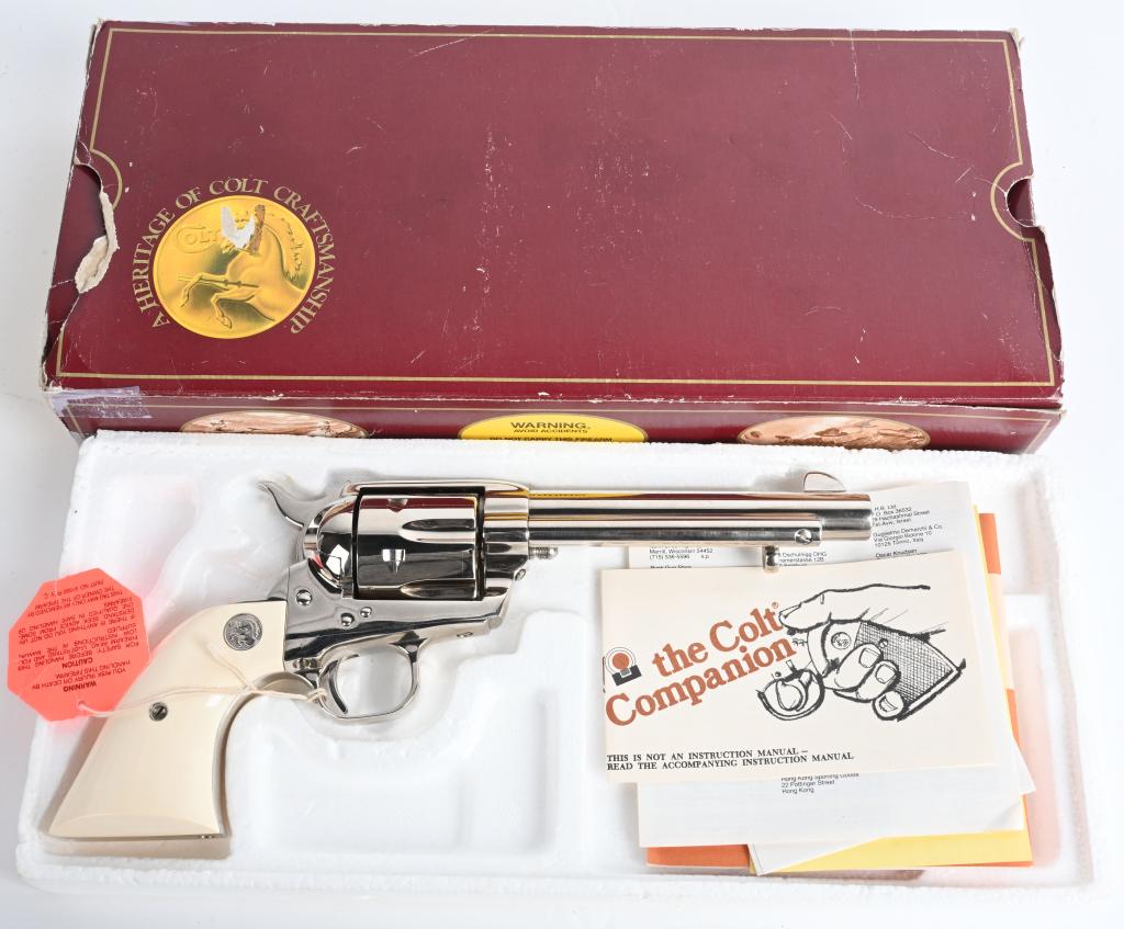 BOXED COLT NICKEL SAA REVOLVER: SERIAL SA71591. BARREL 5.5". CALIBER .45 COLT. MADE IN 1988. Custom shop genuine Emory silver medallion grips, full nickel finish. Matching numbered original cardboard box (tape repairs) with paper wo