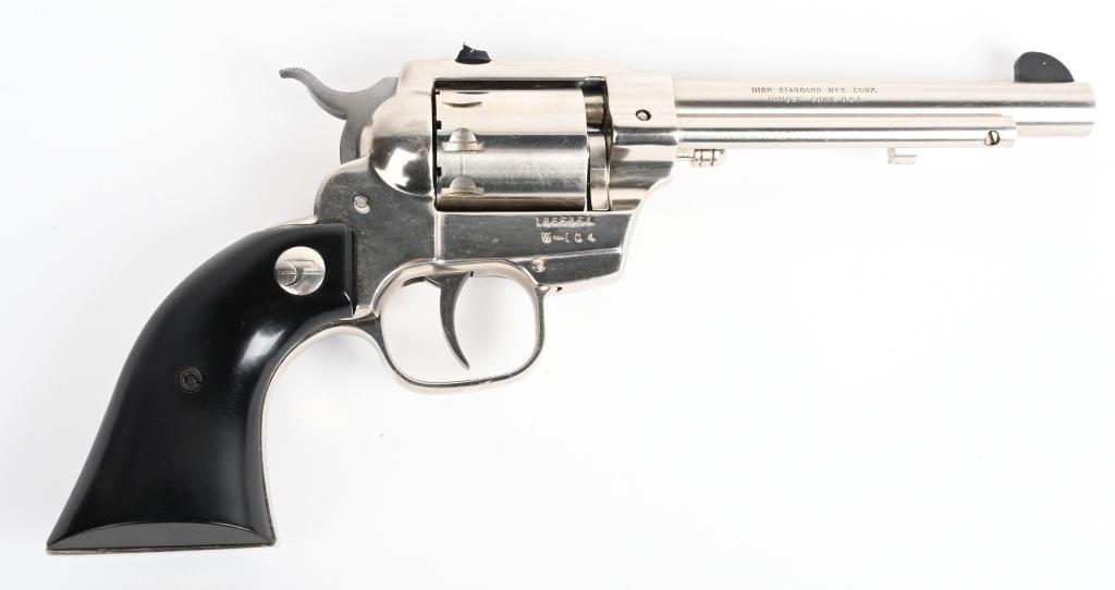 HIGH STANDARD DOUBLE NINE REVOLVER: SERIAL 1865854. BARREL 5.5". CALIBER .22 RIMFIRE. This is a nine shot, double action revolver that resembles a Peacemaker. Features full nickel finish, has a wind drift rear sight and black composite 