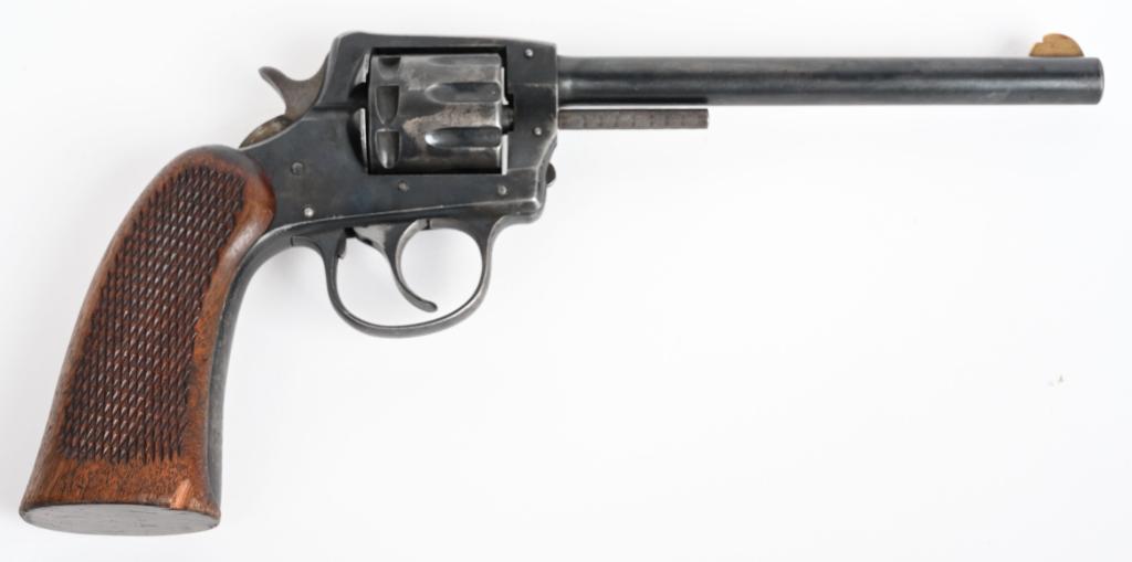 PRE WAR H&R MODEL 922 DOUBLE ACTION REVOLVER: SERIAL 174058. BARREL 6". CALIBER .22 LONG RIFLE. Features a 9-shot, double action, blue finish fixed sights with one piece checkered walnut grips. Made prior to 1942. Metal retains about 75% original