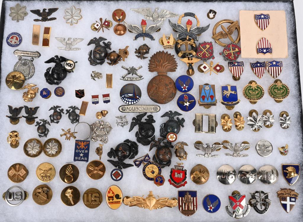 WW1 WWII KOREAN WAR VIETNAM INSIGNIA LOT EGA DI: Large flat of military insignia to include EGA cap and collar insignia, Branch collar Insignia, DI's Rank Badges, Marksmanship medals and lapel insignia from the 1920s to Vietnam