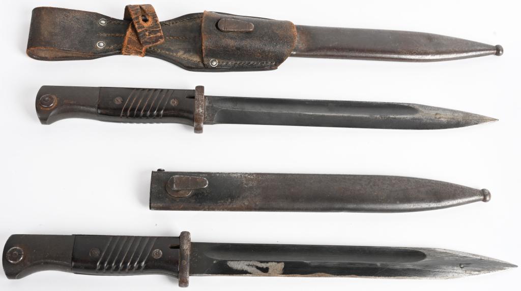 WWII NAZI GERMAN K98 BAYONET LOT OF TWO WW2: WII K98 bayonet lot to include 1) K98 COMBAT BAYONET WITH LEATHER FROG. Roughly 25cm long, drop forged, steel construction blade with wide fullers. Blade retains about most of it's original blueing. M