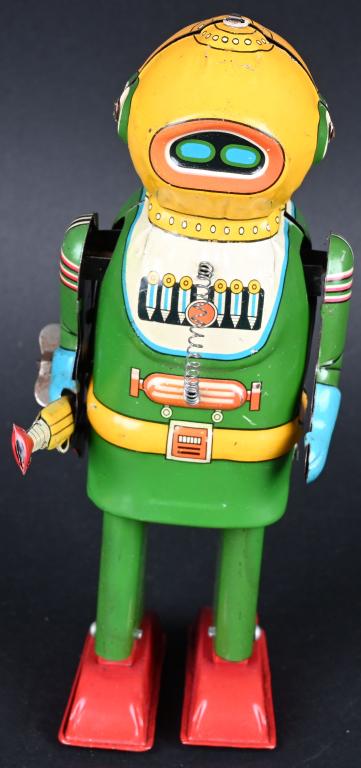 AN TIN WINDUP INTERPLANTARY EXPLORER ROBOT: Naito Shoten tin windup Interplanetary Explorer Robot. Made in Japan. Nice original robot that is complete. The gun has been professionally replaced. Windup works. A very scarce robot. 8" Excellent