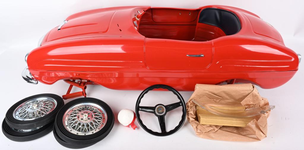 VINTAGE ITALIAN GIORDINI FERRARI PEDAL CAR: Beautiful New Old Stock pedal car with original shiny red paint and chrome details. There is a Girodini decal on the hood and an ESSO decal on the trunk. A superb example of this pedal car. 38", Excel
