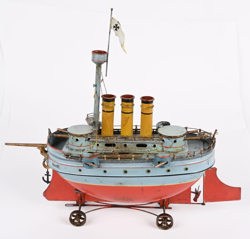 16" GERMAN LIVE STEAM GUN BOAT "GREIFF": Very well made Live Steam Gun Boat. Has cannons all around, 3 smoke stakes, and crows nest. The front has ornate Eagle and Serpent. Comes on rolling stand. A very nice looking Boat. Age and maker unkn