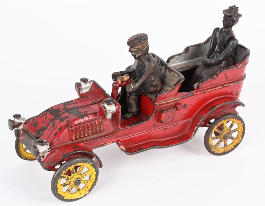 EARLY JONES & BIXLER CAST IRON TOURING CAR: Great looking early car in original paint with no cracks or breaks. Includes original tiller and a cast iron driver and lady passenger. 8 1/2". Very Good