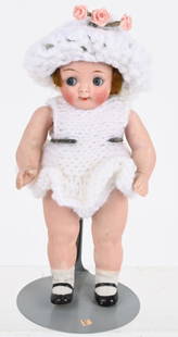 GERMAN BISQUE GOOGLY EYE DOLL: Very cute all bisque doll with original wig. Dressed in a knitted outfit with matching hat. Markings are light on back of head. Retains original wig. Has a 3/16" tight stable hairline on back of head.