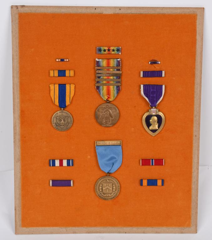 WW1 NAMED MEDAL GROUPING TO A JEWISH SOLDIER WWI: WW1 and WWII family medal grouping including a named, officially engraved purple heart awarded to Raymond E. Siegal and is also numbered 24943 on the edge. Also in the grouping is a 5 bar Winged Victo