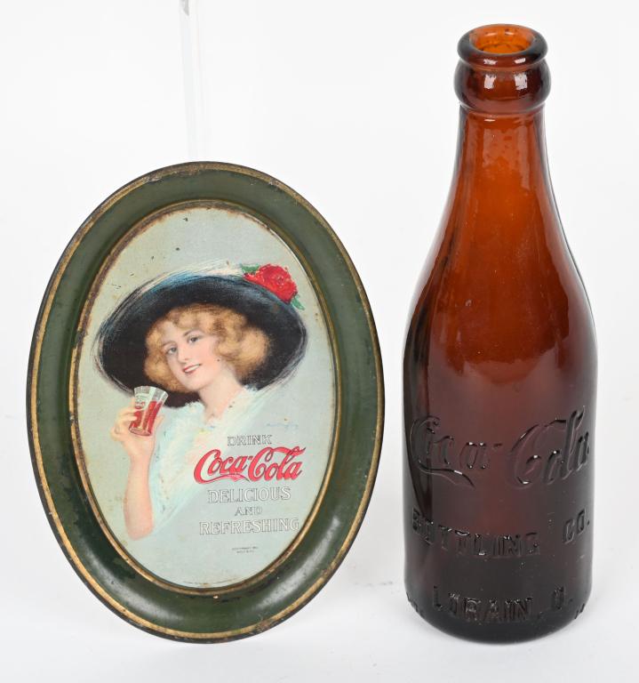 1912 COCA COLA TIP TRAY & AMBER BOTTLE: Very nice 1912 Tip Tray. Still has very nice colors. Plus early 1900s Straight Side Amber Coca Cola Bottle from Lorain, Ohio. Largest 8" Excellent From the James and Helen Berkheimer Collection